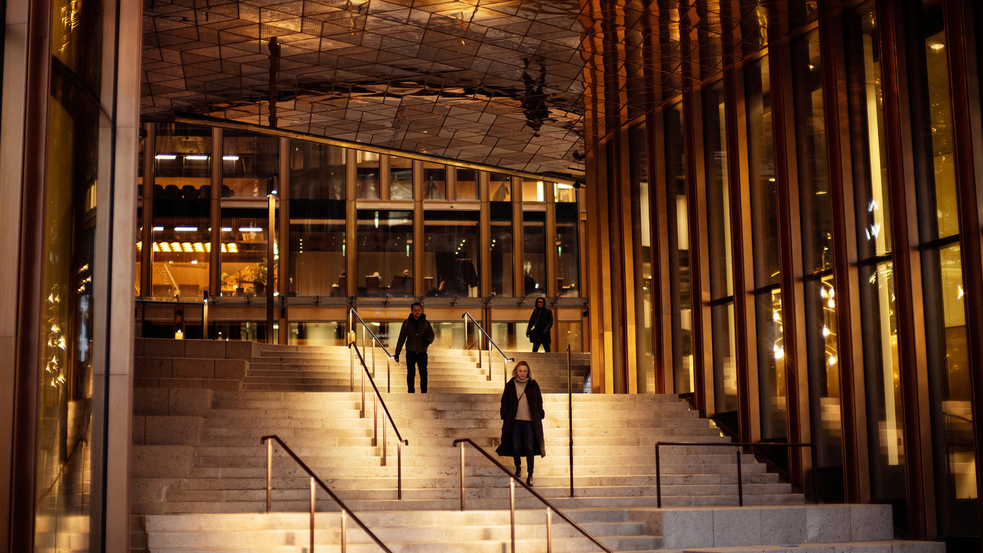 Staircase under the roof of a large office building, in dim lighting. Photo.