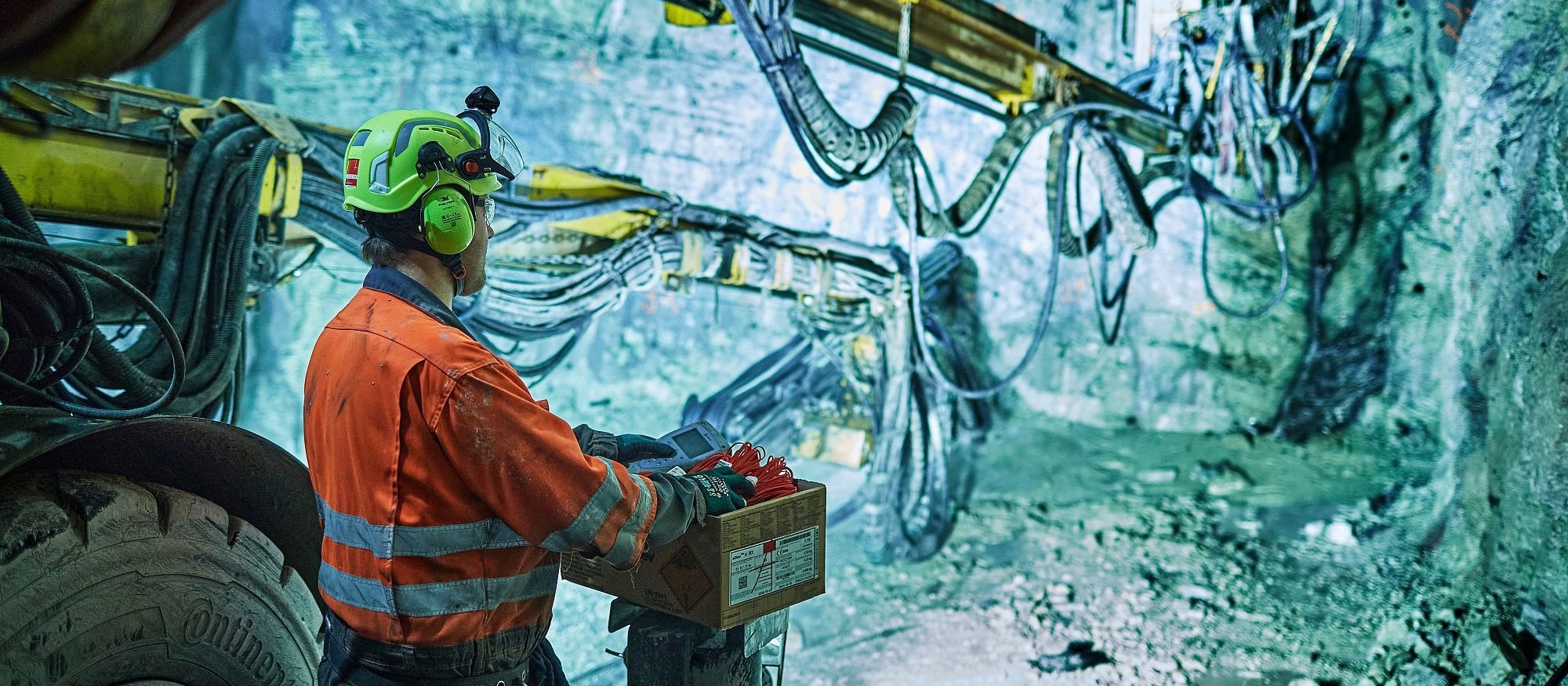 Tunnel worker with machine. Photo.